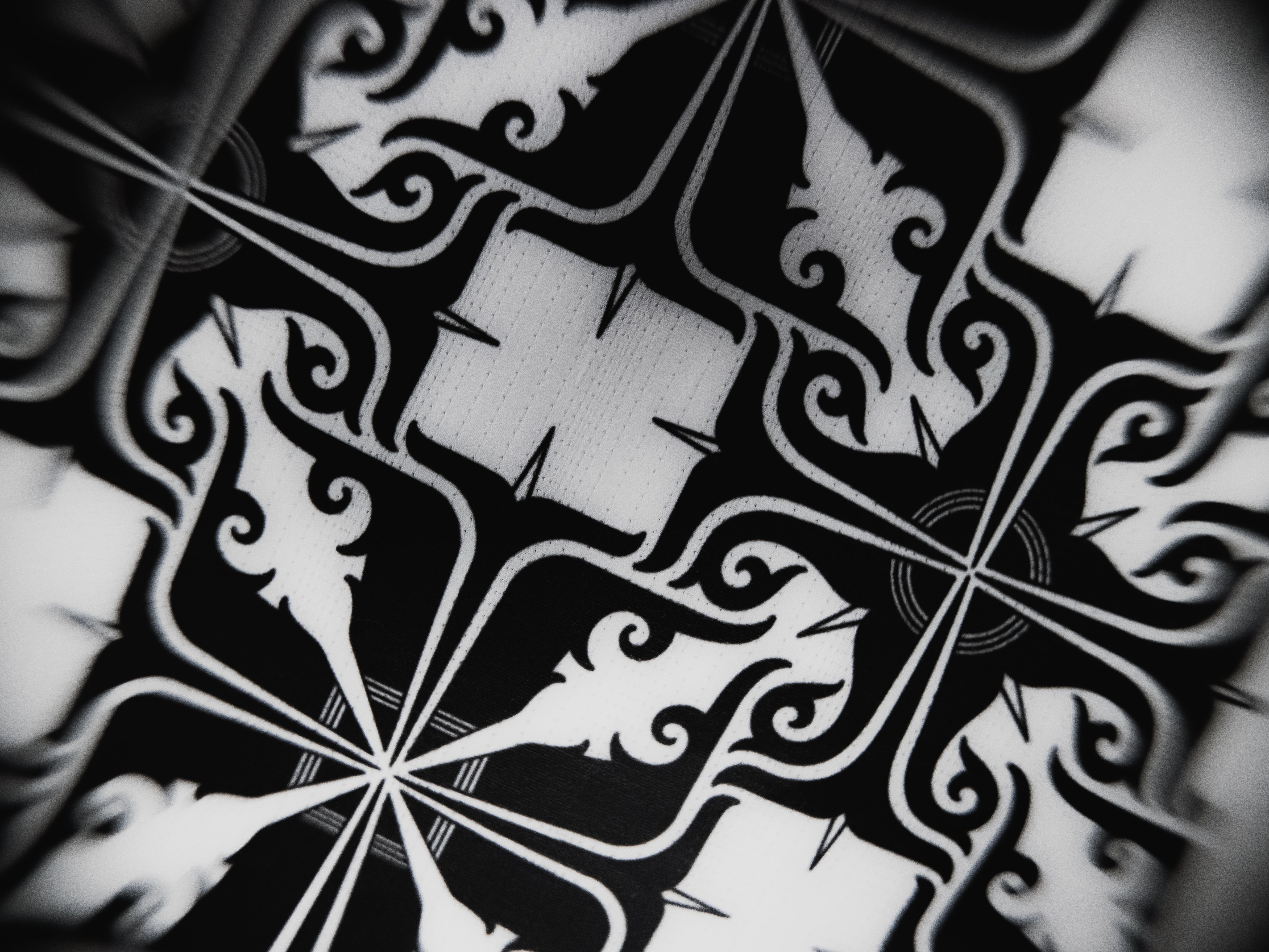 Close-up of the black and white intricate pattern inside the Guile Women's Jiu Jitsu Gi, inspired by traditional designs