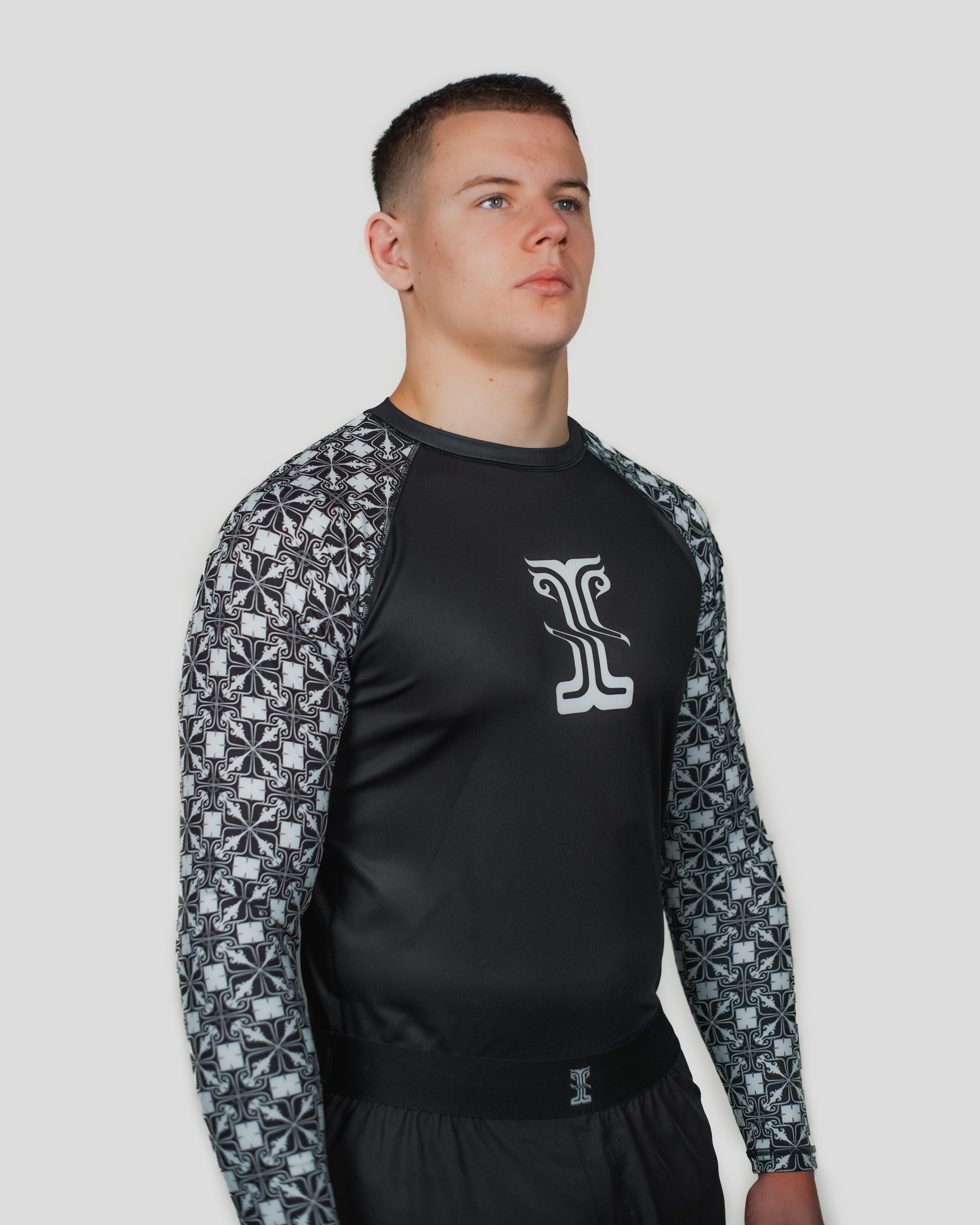 Front view of the Persist Long Sleeve Guard, featuring the Kosmos logo and patterned sleeves for style and performance