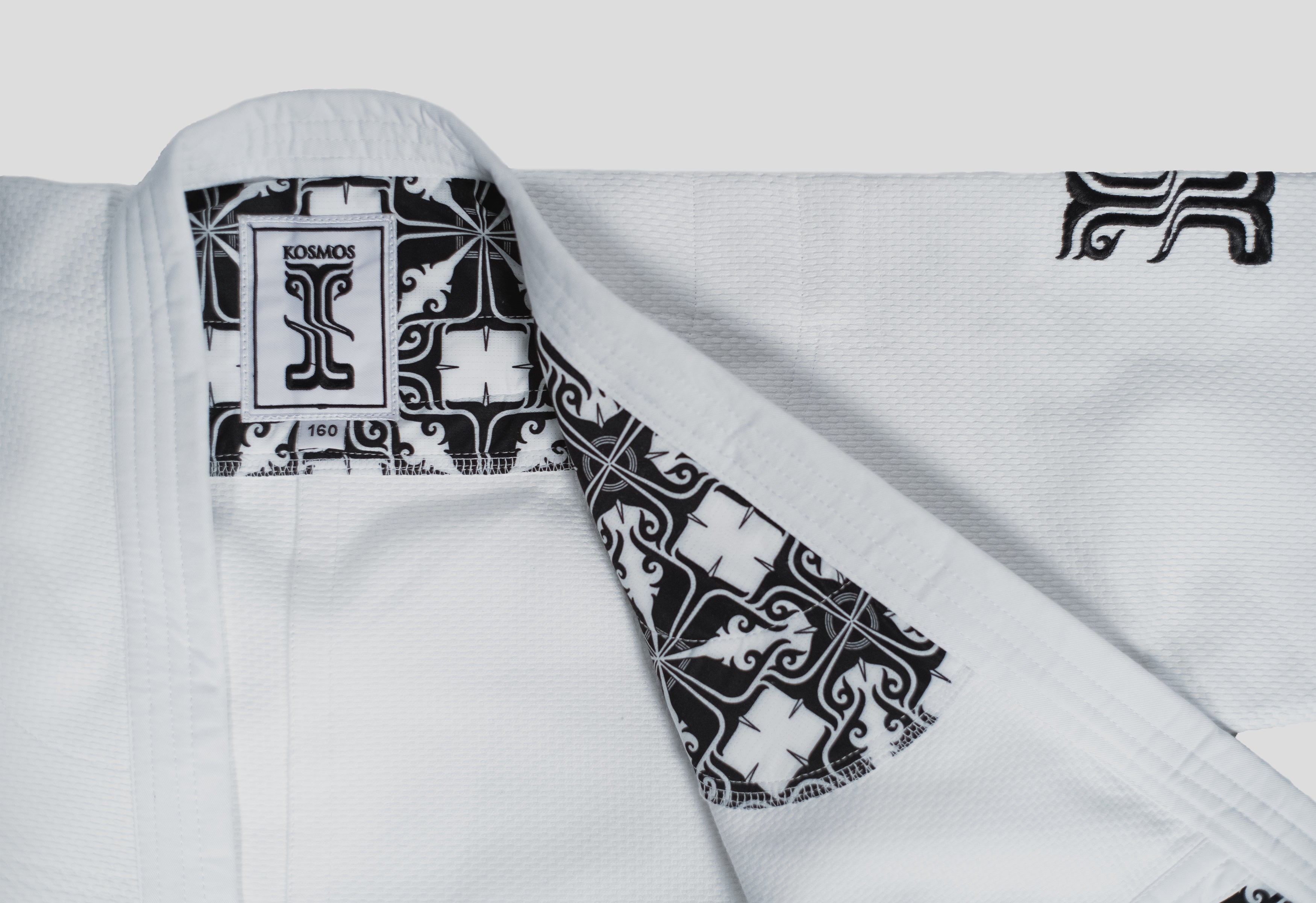 Close-up of the Stoa Gi Women's Judo uniform, showcasing the black and white Kosmos label and the intricate inner lining design